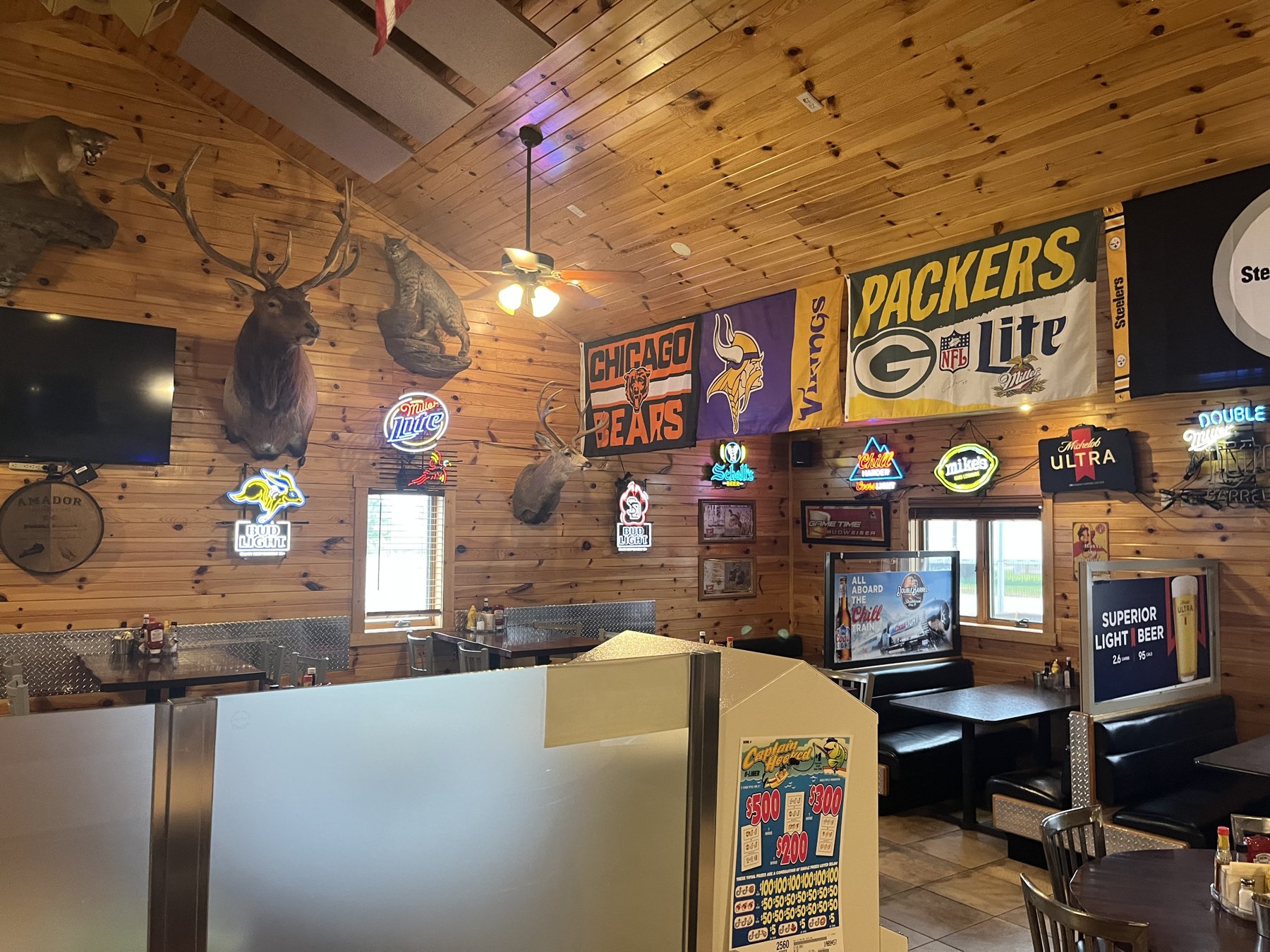 Dining room at Double Barrel — knotty pine, mounts, and TVs